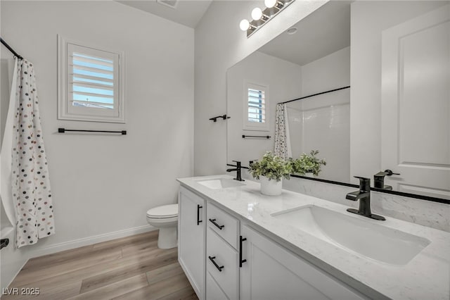 5851 Slate Rock Ct, Las Vegas, NV 89149 - bathroom with double vanity, a shower with curtain, and wood finished floors