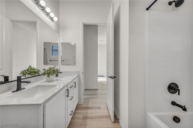 5851 Slate Rock Ct, Las Vegas, NV 89149 - bathroom with wood finished floors, double vanity, and bathing tub / shower combination