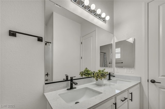 5851 Slate Rock Ct, Las Vegas, NV 89149 - full bathroom featuring double vanity and a textured wall
