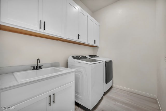 5851 Slate Rock Ct, Las Vegas, NV 89149 - washroom with washer and dryer, cabinet space, and light wood-type flooring