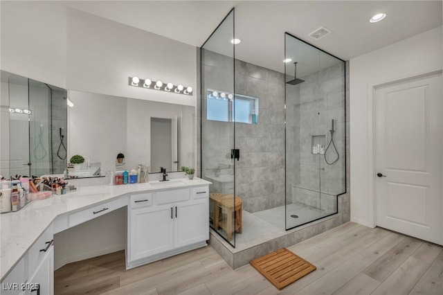 5851 Slate Rock Ct, Las Vegas, NV 89149 - bathroom featuring a shower stall, vanity, wood finished floors, and recessed lighting