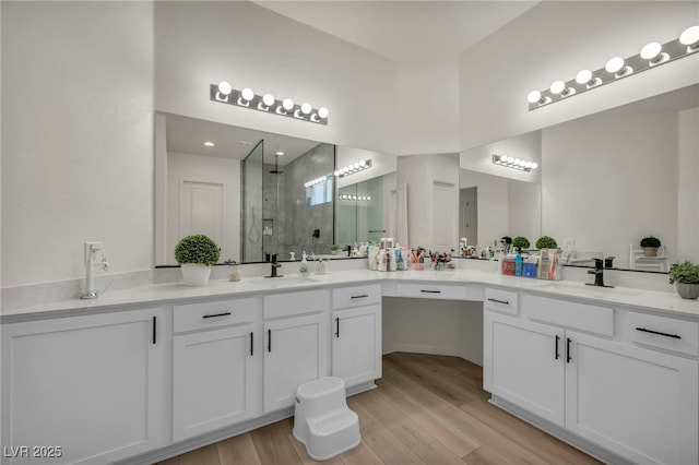 5851 Slate Rock Ct, Las Vegas, NV 89149 - bathroom featuring a shower stall, vanity, wood finished floors, and recessed lighting