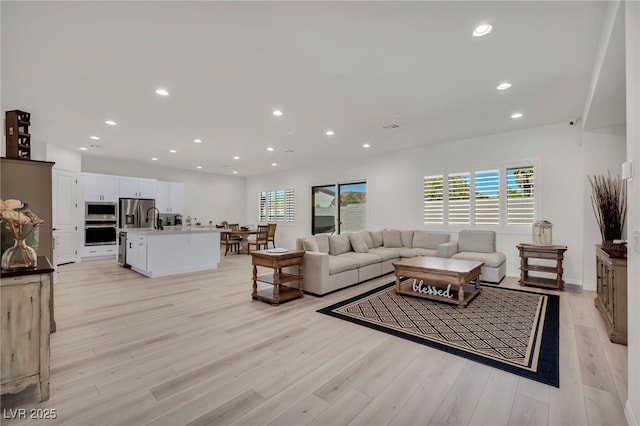 5851 Slate Rock Ct, Las Vegas, NV 89149 - living room with light wood finished floors and recessed lighting