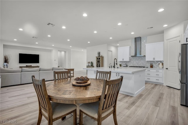 5851 Slate Rock Ct, Las Vegas, NV 89149 - dining area featuring light wood-type flooring and recessed lighting