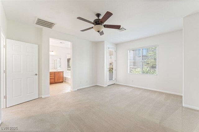 11900 Calle De Sol Dr, Las Vegas, NV 89138 - unfurnished bedroom featuring light carpet, ceiling fan, ensuite bath, and access to outside
