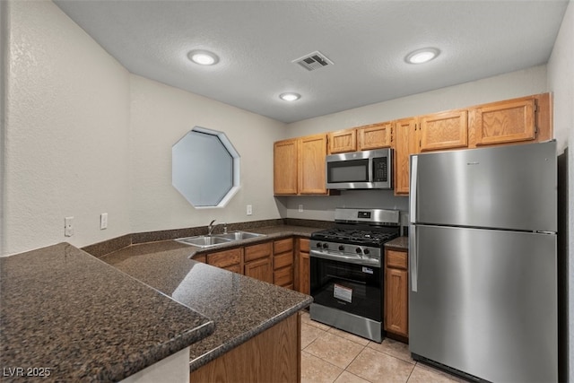 5042 S Rainbow Blvd Unit 206, Las Vegas, NV 89118 - kitchen featuring stainless steel appliances, a peninsula, light tile patterned floors, recessed lighting, and a textured ceiling