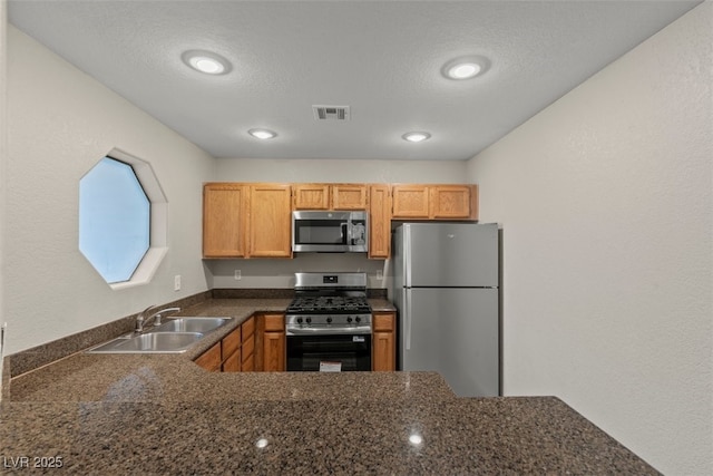 5042 S Rainbow Blvd Unit 206, Las Vegas, NV 89118 - kitchen featuring stainless steel appliances, a textured ceiling, recessed lighting, and a peninsula