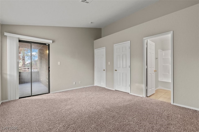 5042 S Rainbow Blvd Unit 206, Las Vegas, NV 89118 - unfurnished bedroom with access to outside, vaulted ceiling, light carpet, and connected bathroom