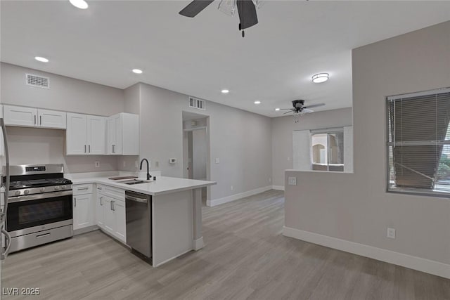 5751 E Hacienda Ave Unit 159, Las Vegas, NV 89122 - kitchen with appliances with stainless steel finishes, a ceiling fan, a peninsula, white cabinets, and recessed lighting