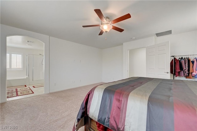 3949 Amanda Bay Ave, North Las Vegas, NV 89081 - carpeted bedroom featuring arched walkways, a ceiling fan, and ensuite bath