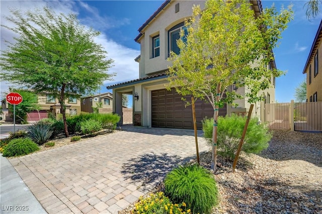 3949 Amanda Bay Ave, North Las Vegas, NV 89081 - view of front of home featuring stucco siding, an attached garage, and decorative driveway