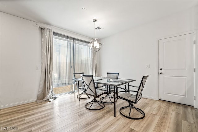 3641 Portici Ln, Henderson, NV 89044 - dining space with light wood-style flooring and a chandelier