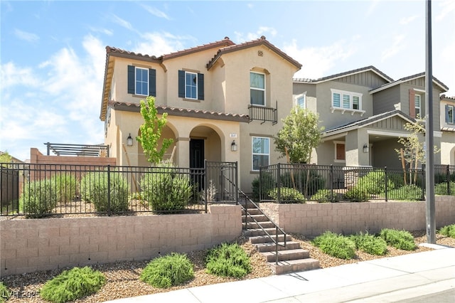 3641 Portici Ln, Henderson, NV 89044 - view of front of house with stucco siding, a fenced front yard, and a tiled roof