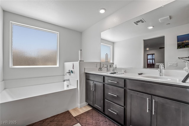 3641 Portici Ln, Henderson, NV 89044 - bathroom featuring plenty of natural light, double vanity, a bath, and recessed lighting