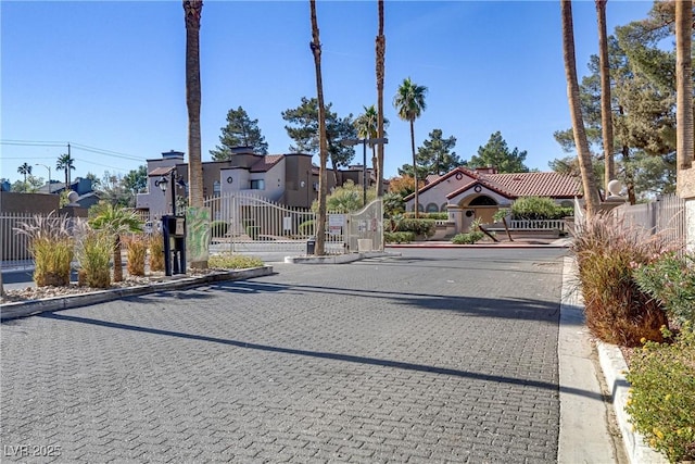 2963 Juniper Hills Blvd Unit 104, Las Vegas, NV 89142 - view of road with curbs, a gate, and a residential view
