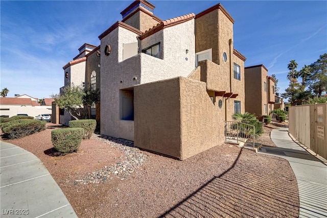 2963 Juniper Hills Blvd Unit 104, Las Vegas, NV 89142 - view of home's exterior featuring a tiled roof and stucco siding