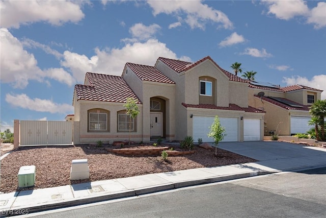 426 Lost Trail Dr, Henderson, NV 89014 - mediterranean / spanish-style home with driveway, stucco siding, a tiled roof, and a garage