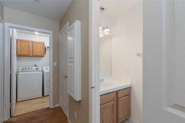426 Lost Trail Dr, Henderson, NV 89014 - bathroom with washer and clothes dryer, wood finished floors, and vanity