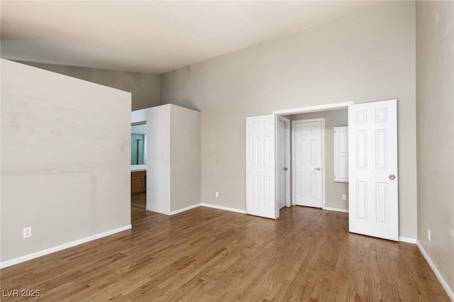 426 Lost Trail Dr, Henderson, NV 89014 - unfurnished bedroom featuring wood finished floors and high vaulted ceiling