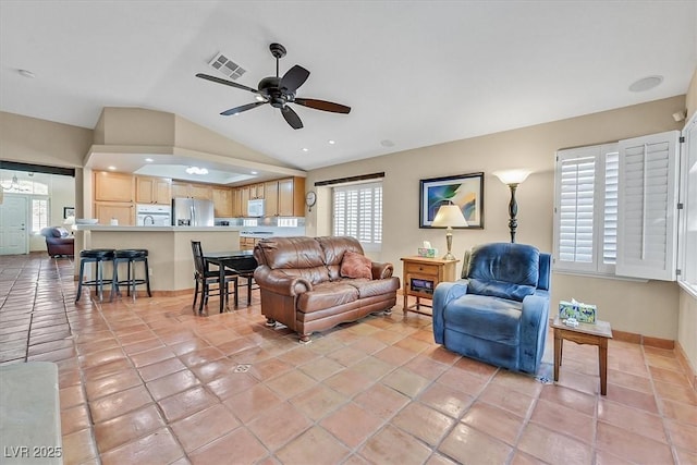 9517 Mountainair Ave, Las Vegas, NV 89134 - living area featuring lofted ceiling, ceiling fan, healthy amount of natural light, and light tile patterned flooring