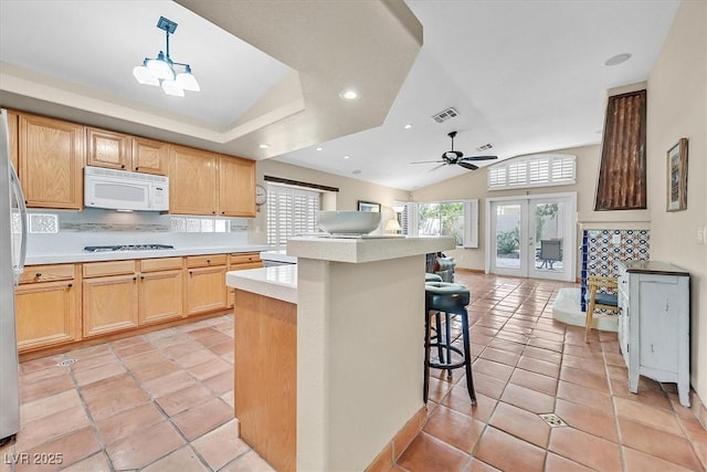 9517 Mountainair Ave, Las Vegas, NV 89134 - kitchen with white appliances, open floor plan, decorative backsplash, light countertops, and vaulted ceiling