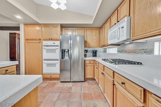 9517 Mountainair Ave, Las Vegas, NV 89134 - kitchen featuring appliances with stainless steel finishes, lofted ceiling, and light brown cabinets
