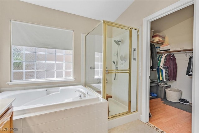 9517 Mountainair Ave, Las Vegas, NV 89134 - bathroom with a shower stall, a bath, a walk in closet, vanity, and wood finished floors