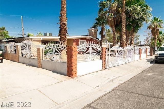 624 N Bruce St, Las Vegas, NV 89101 - view of front of property with a fenced front yard, a gate, and a chimney