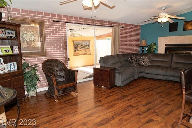 624 N Bruce St, Las Vegas, NV 89101 - living room featuring a ceiling fan, wood finished floors, brick wall, and a fireplace