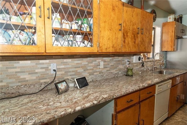624 N Bruce St, Las Vegas, NV 89101 - kitchen featuring dishwasher, tasteful backsplash, and brown cabinetry