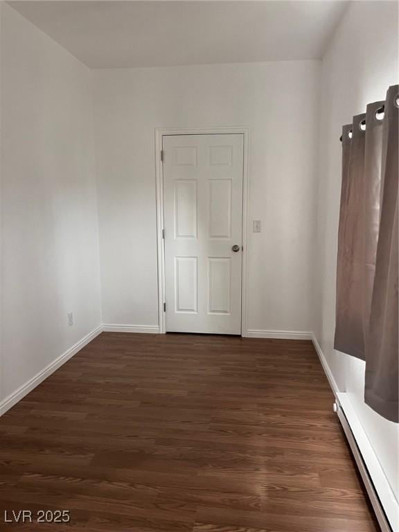 49 Fourth, Mcgill, NV 89318 - spare room featuring a baseboard heating unit and dark wood finished floors