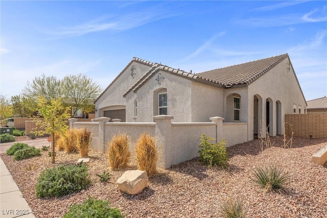 605 Cadence Vista Dr, Henderson, NV 89011 - view of home's exterior featuring a fenced front yard, stucco siding, and a tile roof