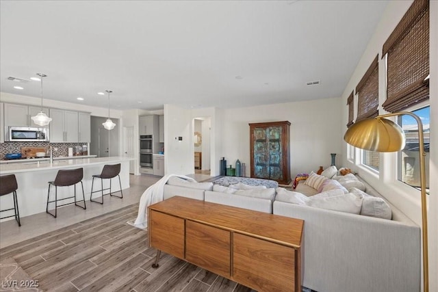 605 Cadence Vista Dr, Henderson, NV 89011 - living area featuring light wood finished floors and recessed lighting