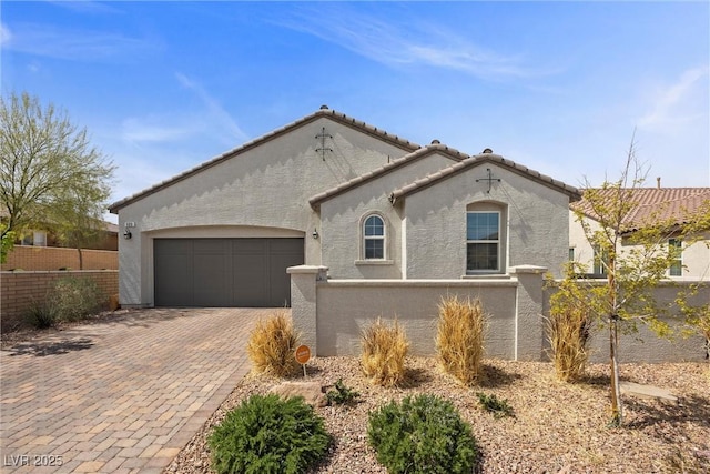 605 Cadence Vista Dr, Henderson, NV 89011 - view of front of home with stucco siding, a garage, decorative driveway, and a tiled roof