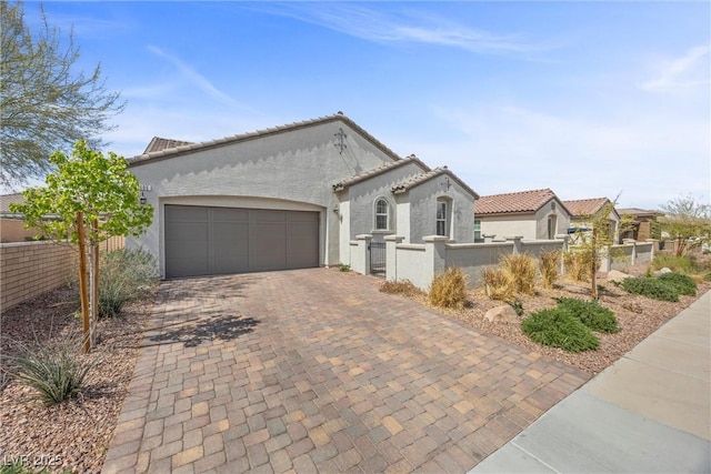 605 Cadence Vista Dr, Henderson, NV 89011 - mediterranean / spanish-style house with stucco siding, a fenced front yard, decorative driveway, and a garage