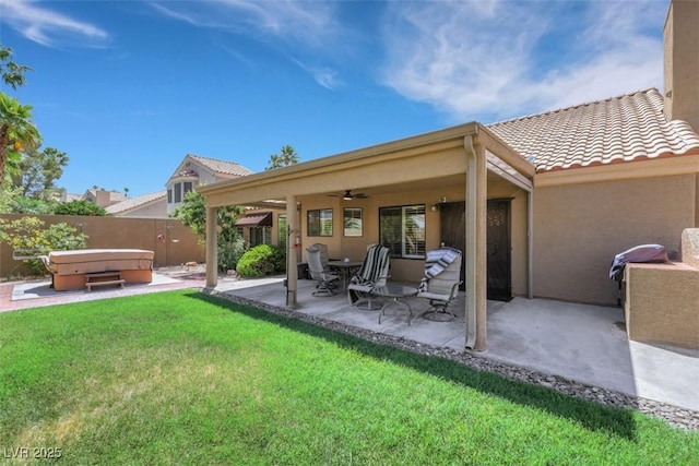 2216 Sapphire Valley St, Las Vegas, NV 89128 - rear view of house with a hot tub, a ceiling fan, a patio, a fenced backyard, and stucco siding