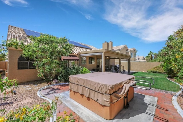 2216 Sapphire Valley St, Las Vegas, NV 89128 - rear view of property with a hot tub, roof mounted solar panels, stucco siding, and a tile roof