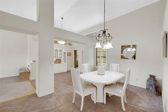 2216 Sapphire Valley St, Las Vegas, NV 89128 - dining area featuring high vaulted ceiling, a chandelier, and stone finish floors