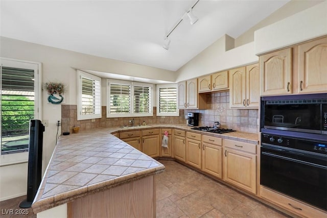 2216 Sapphire Valley St, Las Vegas, NV 89128 - kitchen featuring light brown cabinets, black appliances, rail lighting, lofted ceiling, and tile countertops
