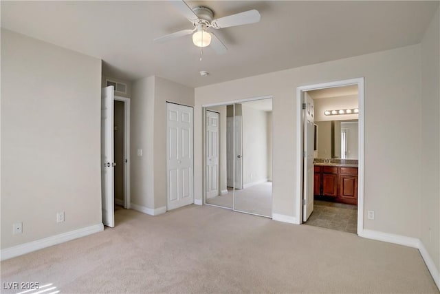 2801 N Rainbow Blvd Unit 273, Las Vegas, NV 89108 - unfurnished bedroom with light carpet, multiple closets, and ensuite bath