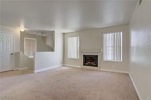 2801 N Rainbow Blvd Unit 273, Las Vegas, NV 89108 - unfurnished living room featuring carpet floors, healthy amount of natural light, a ceiling fan, and a tile fireplace