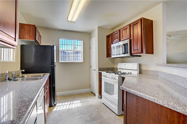 2801 N Rainbow Blvd Unit 273, Las Vegas, NV 89108 - kitchen with appliances with stainless steel finishes and a ceiling fan