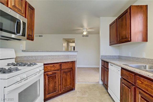 2801 N Rainbow Blvd Unit 273, Las Vegas, NV 89108 - kitchen featuring white appliances, light countertops, ceiling fan, and a peninsula