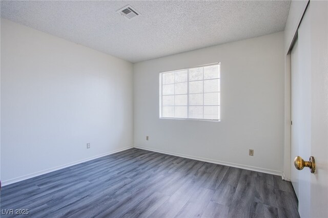 2696 Jennydiane Dr, Las Vegas, NV 89121 - spare room featuring dark wood-style flooring and a textured ceiling