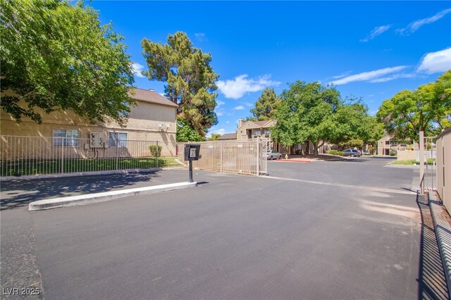 2696 Jennydiane Dr, Las Vegas, NV 89121 - view of asphalt street with a gated entry and curbs