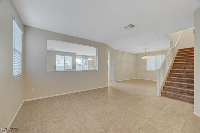 189 Paxon Hollow Ct, Las Vegas, NV 89148 - empty room featuring a chandelier, stairs, plenty of natural light, and light tile patterned floors