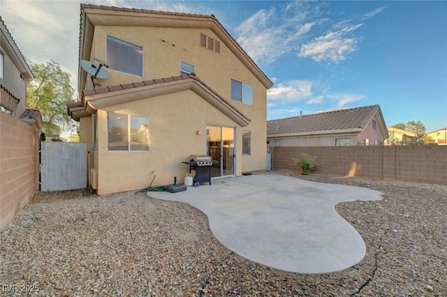 189 Paxon Hollow Ct, Las Vegas, NV 89148 - rear view of property featuring stucco siding, a fenced backyard, a patio, and a tiled roof