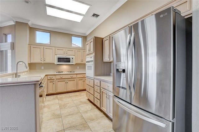 1904 Hot Oak Ridge St, Las Vegas, NV 89134 - kitchen featuring white appliances, crown molding, light brown cabinetry, light countertops, and light tile patterned flooring