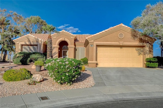 1904 Hot Oak Ridge St, Las Vegas, NV 89134 - mediterranean / spanish-style home with stucco siding, a tiled roof, an attached garage, and driveway