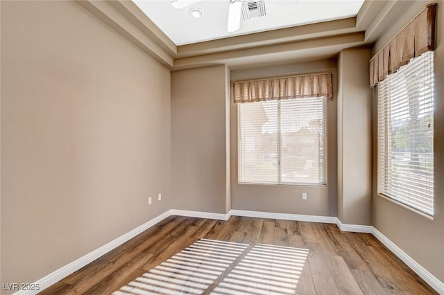 1904 Hot Oak Ridge St, Las Vegas, NV 89134 - unfurnished room featuring wood finished floors and a tray ceiling